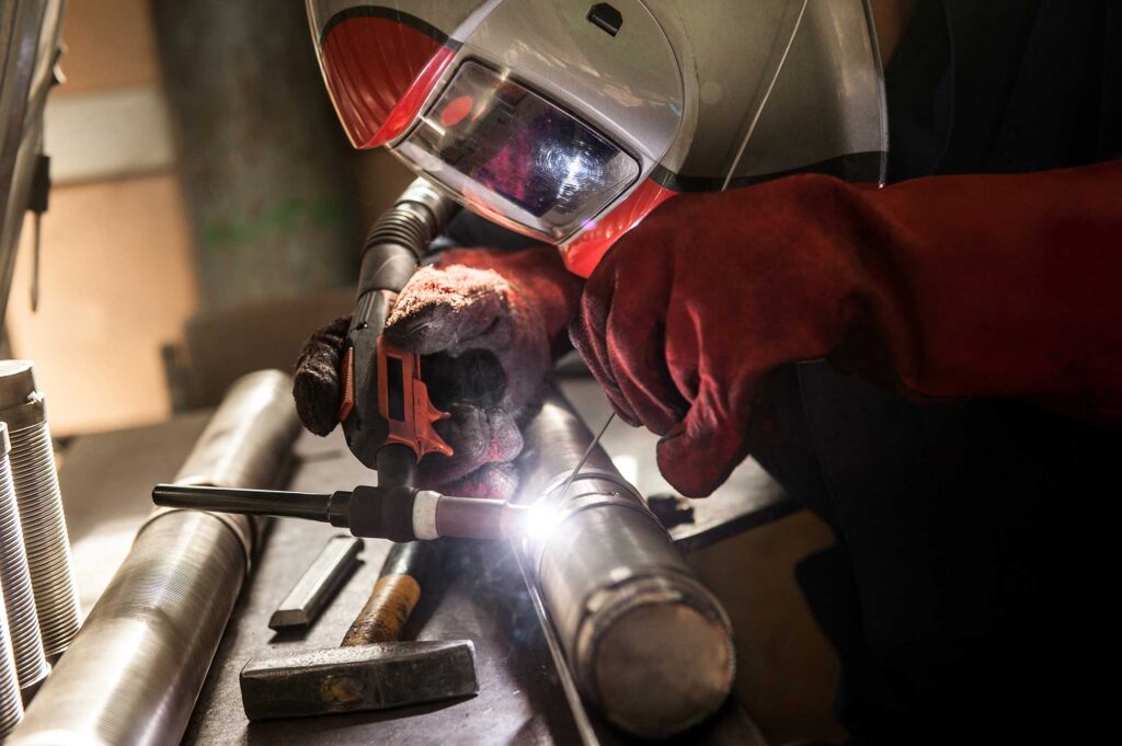 closeup-of-man-wearing-mask-welding-in-a-workshop-2024-05-30-07-41-37-utc