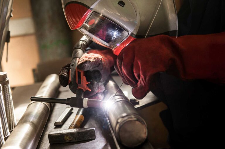 closeup-of-man-wearing-mask-welding-in-a-workshop-2024-05-30-07-41-37-utc